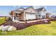 Charming home exterior boasts a lush landscaped yard and attached two-car garage at 2276 Marjorie Way, Shelbyville, IN 46176