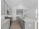 Modern kitchen features stainless steel appliances, sleek gray cabinets, and a spacious quartz countertop island at 2276 Marjorie Way, Shelbyville, IN 46176