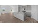 Open-concept kitchen with quartz island and stainless appliances flows seamlessly into the bright and airy living space at 2276 Marjorie Way, Shelbyville, IN 46176