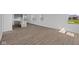 Spacious living area with wood floors, showcasing the open layout and abundant natural light, with kitchen access at 2276 Marjorie Way, Shelbyville, IN 46176