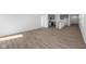 Open-concept living space features wood floors and seamless transition to the modern kitchen, perfect for entertaining at 2276 Marjorie Way, Shelbyville, IN 46176