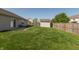Large backyard showcasing a storage shed, concrete patio, grassy area, and a sturdy wooden fence at 2923 Armaugh Dr, Brownsburg, IN 46112