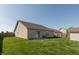Well-maintained backyard featuring a patio, lush green grass, and wood privacy fence at 2923 Armaugh Dr, Brownsburg, IN 46112