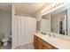 Functional bathroom featuring a vanity, sink, and shower with neutral-toned curtain at 2923 Armaugh Dr, Brownsburg, IN 46112