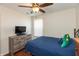Comfortable bedroom with hardwood floors, ceiling fan, and a dresser with plenty of storage space at 2923 Armaugh Dr, Brownsburg, IN 46112