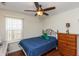 Charming bedroom featuring hardwood floors, ceiling fan, and a classic wooden dresser at 2923 Armaugh Dr, Brownsburg, IN 46112