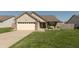 Charming single-Gathering home featuring a well-manicured lawn and an attached two-car garage at 2923 Armaugh Dr, Brownsburg, IN 46112