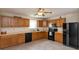 Efficient kitchen with black appliances, ample counter space, and an abundance of wood cabinets at 2923 Armaugh Dr, Brownsburg, IN 46112