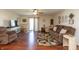 Spacious living area with hardwood floors, a ceiling fan, and access to the backyard at 2923 Armaugh Dr, Brownsburg, IN 46112
