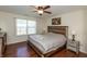 Comfortable main bedroom with wooden bed frame, ceiling fan, and natural light from the window at 2923 Armaugh Dr, Brownsburg, IN 46112