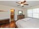Spacious main bedroom featuring wood floors, ceiling fan, and access to the en-suite bathroom at 2923 Armaugh Dr, Brownsburg, IN 46112