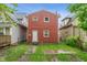 Exterior rear view of a two-story home with a cozy backyard and patio space at 2935 Highland Pl, Indianapolis, IN 46208