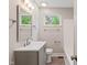 Bright bathroom featuring modern vanity, tub, and fixtures under natural light at 2935 Highland Pl, Indianapolis, IN 46208