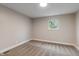 Cozy bedroom showcasing plush carpeting, neutral tones, and natural light through a single window at 2935 Highland Pl, Indianapolis, IN 46208