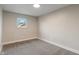 A carpeted bedroom space featuring neutral colored paint and a single window at 2935 Highland Pl, Indianapolis, IN 46208