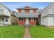Two-story home with red siding and a metal awning-style roof over the front porch at 2935 Highland Pl, Indianapolis, IN 46208