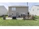 Large backyard with a concrete patio, wooden deck, and plenty of green space at 3189 Underwood Dr, Whiteland, IN 46184