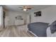 This bedroom features natural light, wood-look flooring, ceiling fan, and mounted TV at 3189 Underwood Dr, Whiteland, IN 46184