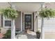 Welcoming front entrance adorned with lush ferns and a cozy welcome mat at 3189 Underwood Dr, Whiteland, IN 46184