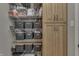 Pantry featuring wire shelving, organized storage baskets, and wood cabinets for optimal organization at 3189 Underwood Dr, Whiteland, IN 46184