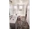 Well-lit bathroom featuring a shower, modern vanity, and eye catching flooring at 3532 E 10Th St, Indianapolis, IN 46201
