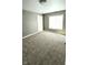Bright bedroom featuring neutral walls, plush carpet, and a window for natural light at 3532 E 10Th St, Indianapolis, IN 46201