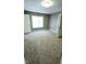 Spacious bedroom with plush carpet, natural light and a conveniently located entry doorway at 3532 E 10Th St, Indianapolis, IN 46201
