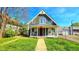 Charming front exterior with a peaked roof, quaint porch, and well-maintained lawn at 3532 E 10Th St, Indianapolis, IN 46201