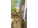 View of the side yard showing the side of the house and landscaping at 3532 E 10Th St, Indianapolis, IN 46201