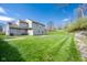 Expansive back yard with a grassy lawn and patio perfect for outdoor entertaining at 3611 Owster Ln, Indianapolis, IN 46237