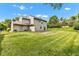 Expansive backyard with a lush lawn, mature trees, and patio, ideal for outdoor gatherings at 3611 Owster Ln, Indianapolis, IN 46237
