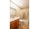 Standard bathroom with wood vanity, toilet, and shower/tub combo with shower curtain at 3611 Owster Ln, Indianapolis, IN 46237