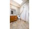 Bright bathroom with oak vanity and floral wallpaper and skylight at 3611 Owster Ln, Indianapolis, IN 46237