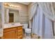 Classic bathroom with decorative wallpaper, vanity, and shower curtain at 3611 Owster Ln, Indianapolis, IN 46237