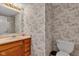 Bathroom featuring vintage wallpaper, a toilet, and a vanity at 3611 Owster Ln, Indianapolis, IN 46237