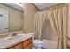 Cozy bathroom featuring a shower-tub combination with patterned wallpaper, vanity, and ample lighting at 3611 Owster Ln, Indianapolis, IN 46237