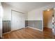 Bedroom featuring wood floor, white trim at the ceiling, and double closet at 3611 Owster Ln, Indianapolis, IN 46237