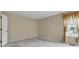 Neutral-toned bedroom with plush carpet and natural light from the window at 3611 Owster Ln, Indianapolis, IN 46237