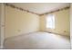 Empty bedroom with wall-to-wall carpet, trim at ceiling and window with blinds at 3611 Owster Ln, Indianapolis, IN 46237