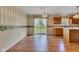 Bright dining area with hardwood floors, featuring sliding glass doors to the outdoor space and classic lighting at 3611 Owster Ln, Indianapolis, IN 46237
