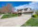 Well-maintained two-story home with manicured lawn and mature flowering tree at 3611 Owster Ln, Indianapolis, IN 46237