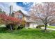 Charming two-story home boasting a lush lawn and mature trees in full bloom at 3611 Owster Ln, Indianapolis, IN 46237