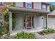 Inviting front porch with gray siding, red shutters, and a well-maintained landscape with plants and flowers at 3611 Owster Ln, Indianapolis, IN 46237