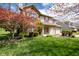 Charming two-story home with brick accents, flowering tree, and well-manicured lawn at 3611 Owster Ln, Indianapolis, IN 46237