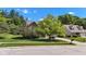 Charming two-story home with a landscaped front yard and mature trees, perfect for a Gathering at 3611 Owster Ln, Indianapolis, IN 46237