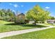 Charming home features a well-manicured lawn, mature tree, and inviting curb appeal on a sunny day at 3611 Owster Ln, Indianapolis, IN 46237