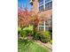Charming brick accents, lush landscaping, and flowering tree highlight the curb appeal at 3611 Owster Ln, Indianapolis, IN 46237