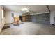 A spacious garage with a two car door, storage shelves, and ample room for vehicles and storage at 3611 Owster Ln, Indianapolis, IN 46237