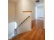 Hallway with hardwood floors leading to stairs and other rooms at 3611 Owster Ln, Indianapolis, IN 46237