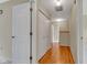 Upper level hallway showcasing beautiful hardwood floors and ample closet space at 3611 Owster Ln, Indianapolis, IN 46237